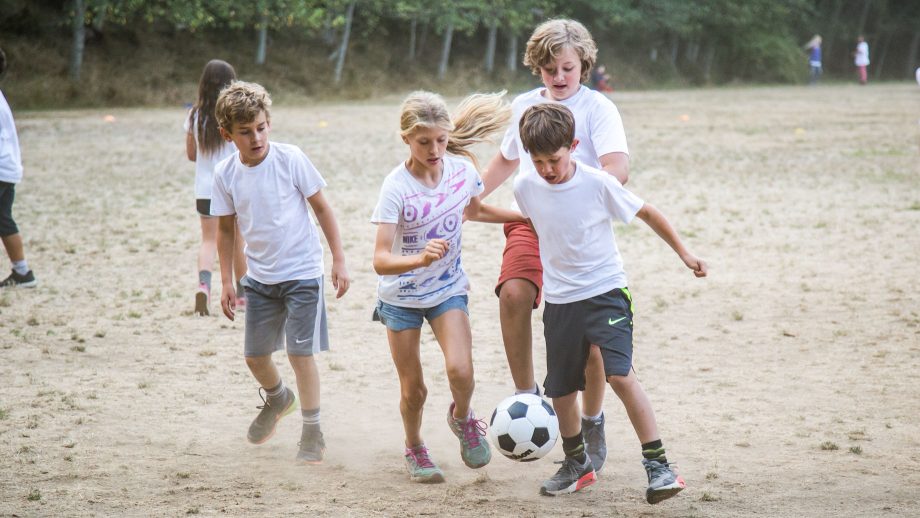 Campers go for ball during soccer match