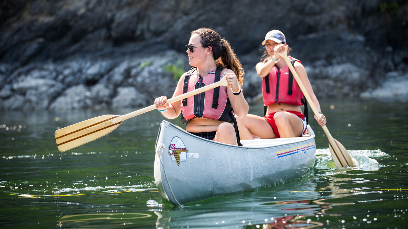 Girls canoeing at summer camp