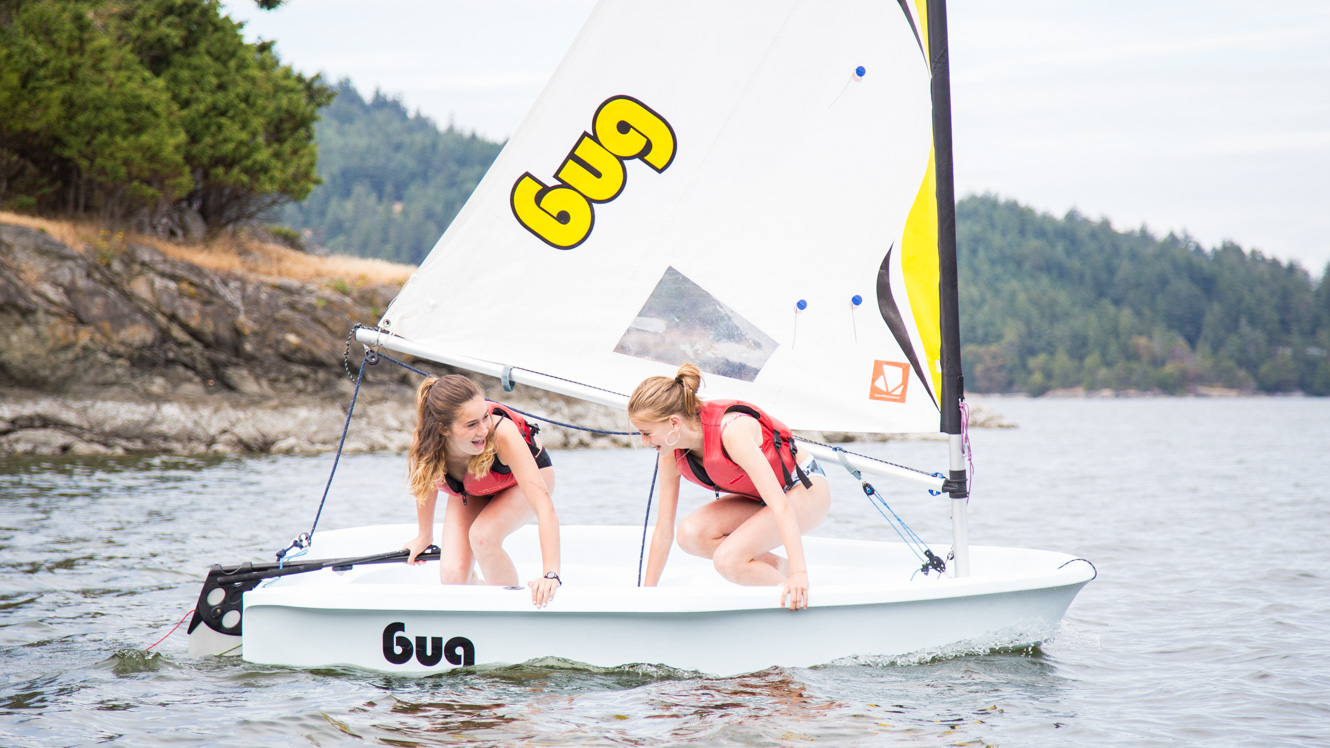 Girls in sailboat at summer camp