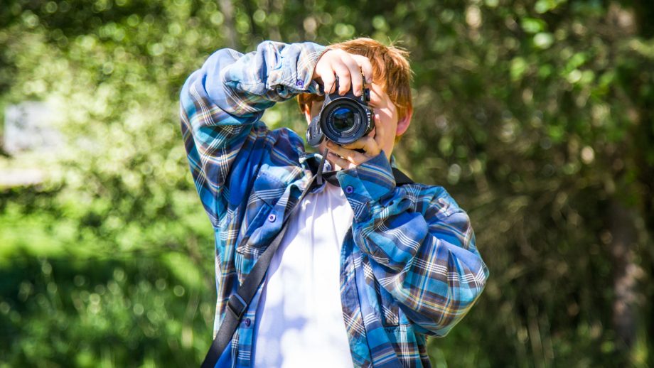 Camper take digital photos at summer camp